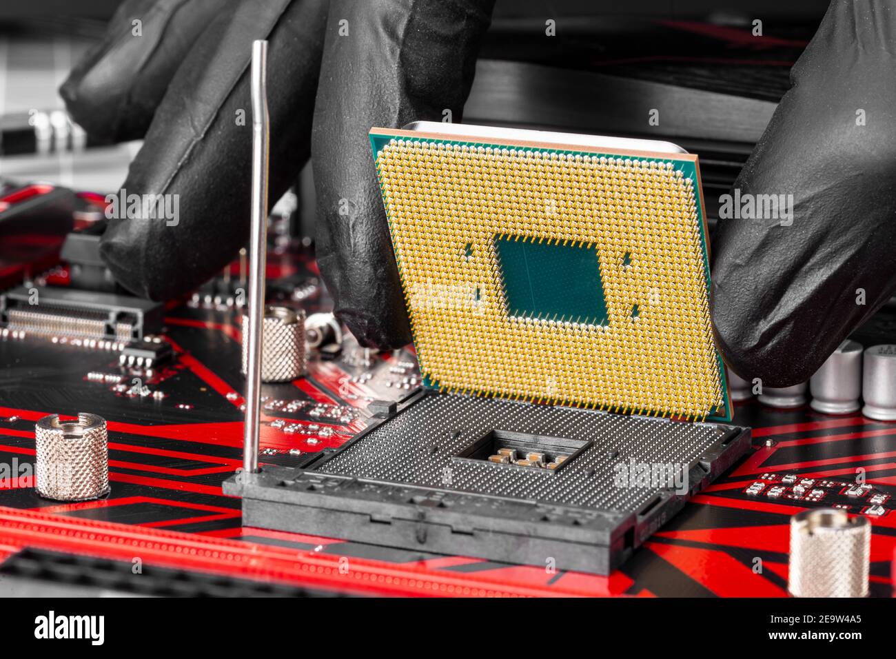 Main avec le processeur lors de l'installation d'un processeur d'ordinateur dans le support de la carte mère. Mise à niveau de la technologie matérielle du PC, présentation du concept de réparation Banque D'Images