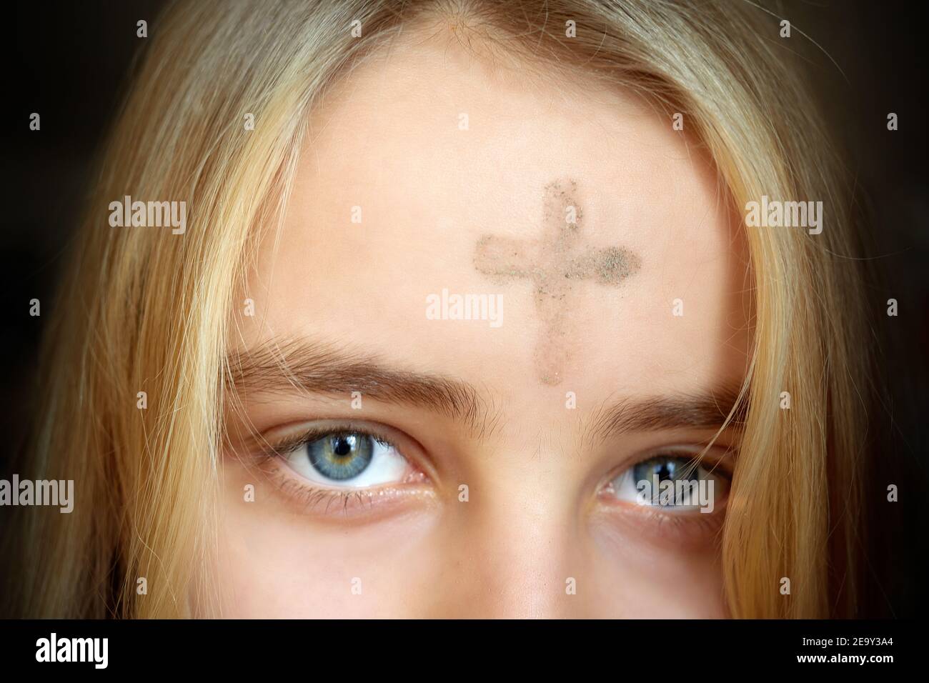 Fille avec croix faite de cendres sur le front. Concept de mercredi de cendres. Banque D'Images