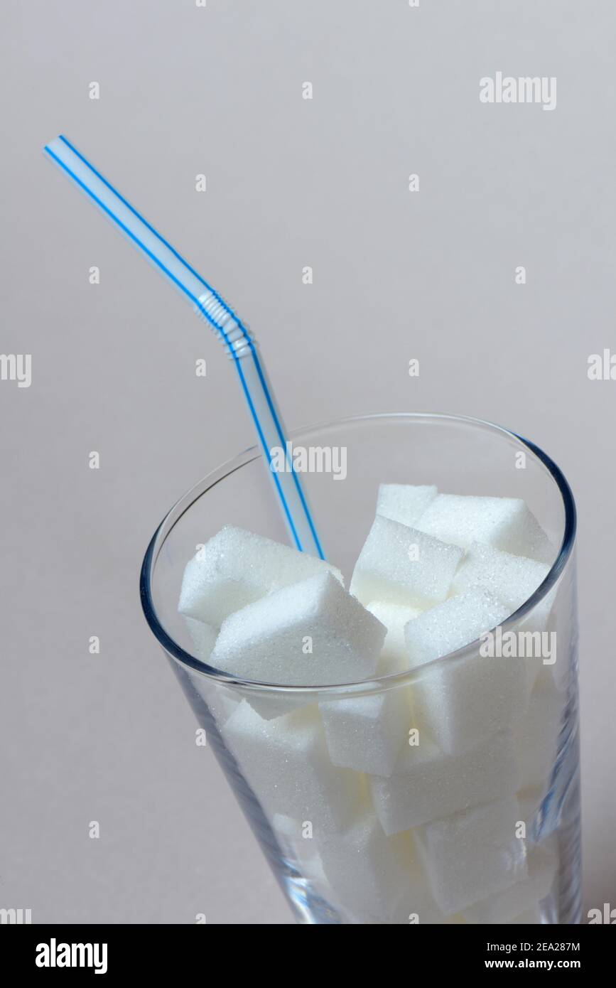 Cubes de sucre en verre à boire avec paille, consommation de sucre, sucre blanc, sucre de betterave Banque D'Images