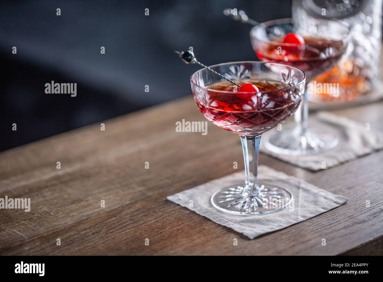 Cocktail classique de Manhattan en apéritif avec whisky, vermouth, angostura aromatique amer et garniture de cerise. Banque D'Images