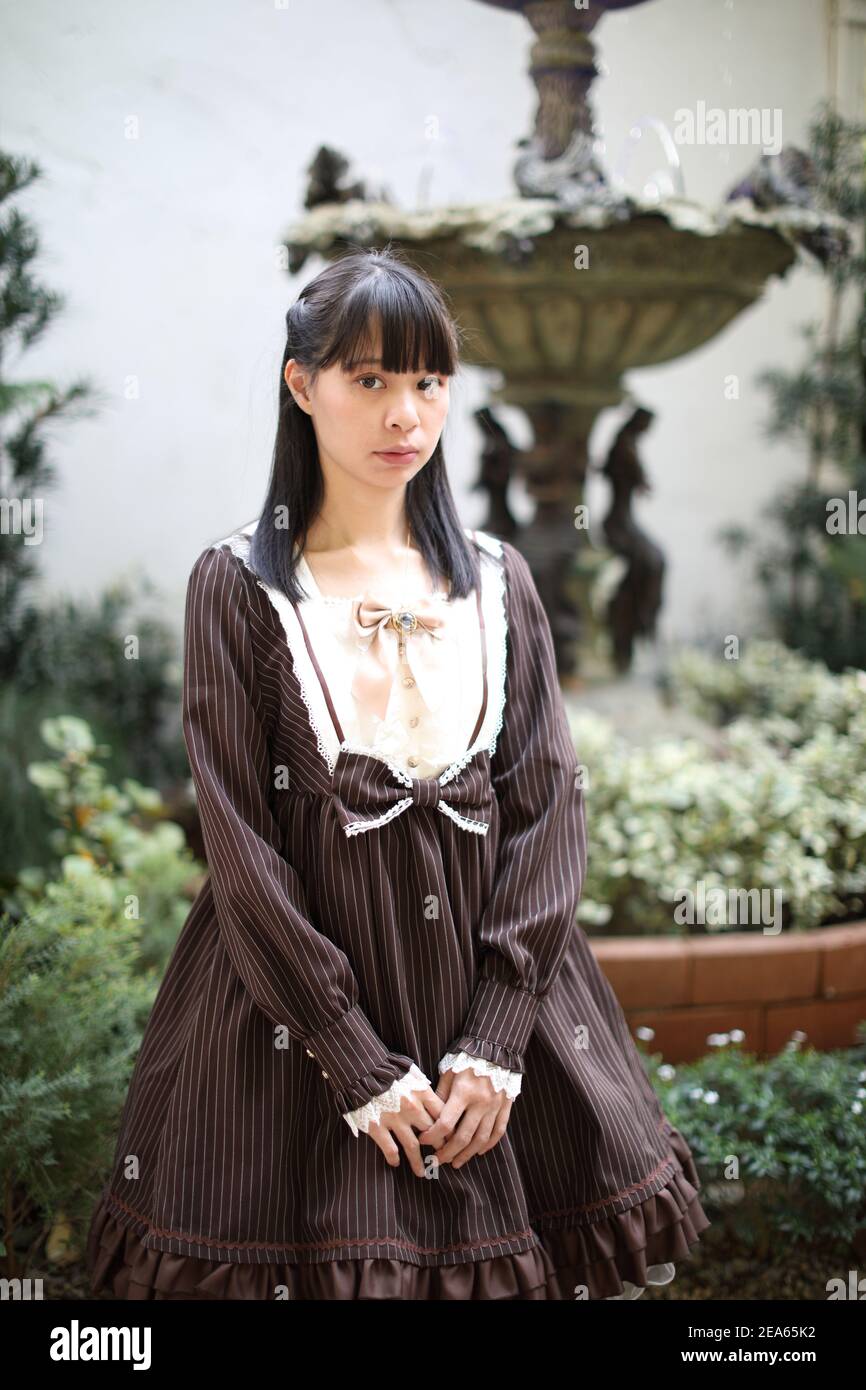 Portrait de fille asiatique avec fond de fleurs violettes Banque D'Images