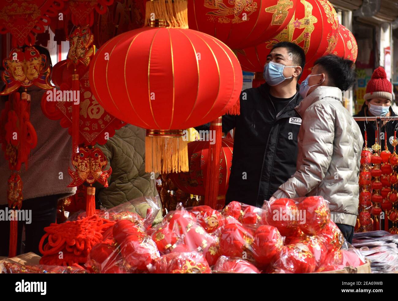 Les gens portant des masques de visage achètent des ornements du nouvel an sur le marché sanliwan à Fuyang City.a l'approche du Spring Festival, les gens continuent à faire du shopping pour des couplets avec la bénédiction des personnages et de célébrer le nouvel an lunaire à venir en Chine. Pour éviter la propagation de la COVID-19, le gouvernement chinois a encouragé les gens à passer leur nouvel an lunaire localement, ce qui a stimulé la consommation dans les villes locales. (Photo de Sheldon Cooper / SOPA Images / Sipa USA) Banque D'Images