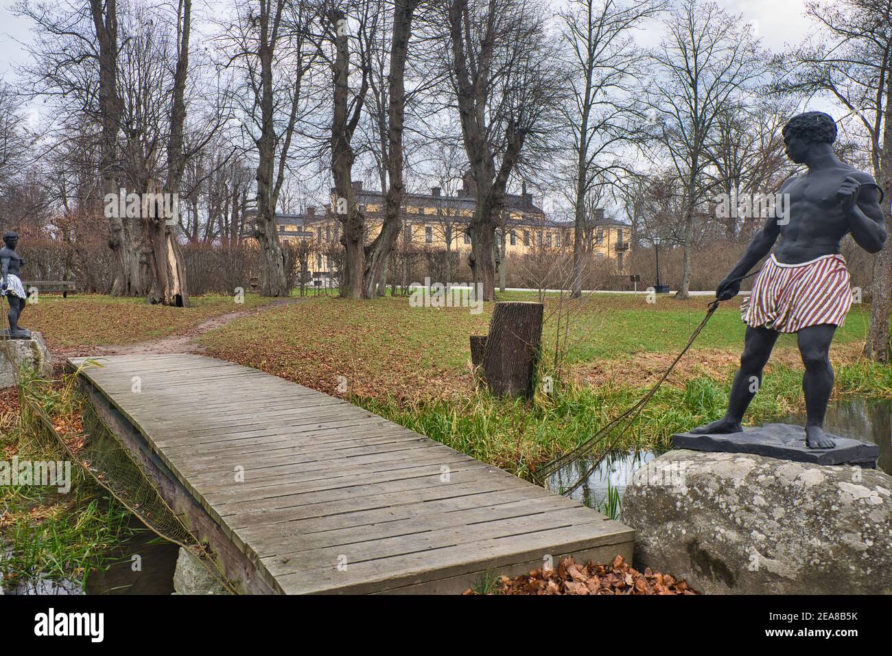 Deux sculptures masculines noires peintes en bronze représentées tirant un filet de pêche sous le Morianbron (pont de Blackamoor), Palais Ulriksdal, Stockholm, Suède Banque D'Images