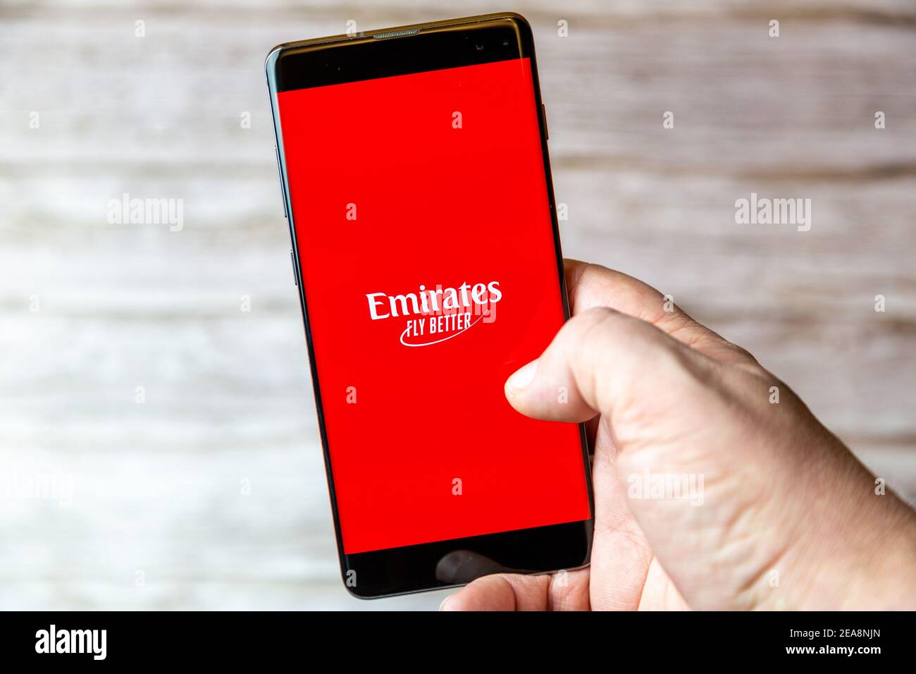 Un téléphone mobile ou mobile tenu dans un Main avec l'application Emirates  Fly Better ouverte à l'écran Photo Stock - Alamy