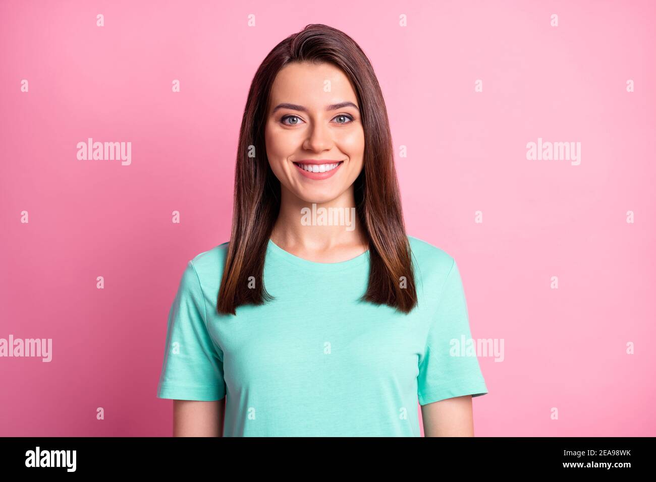 Photo portrait d'une jeune fille gaie souriante portant un t-shirt sarcelle isolé sur fond rose pastel Banque D'Images