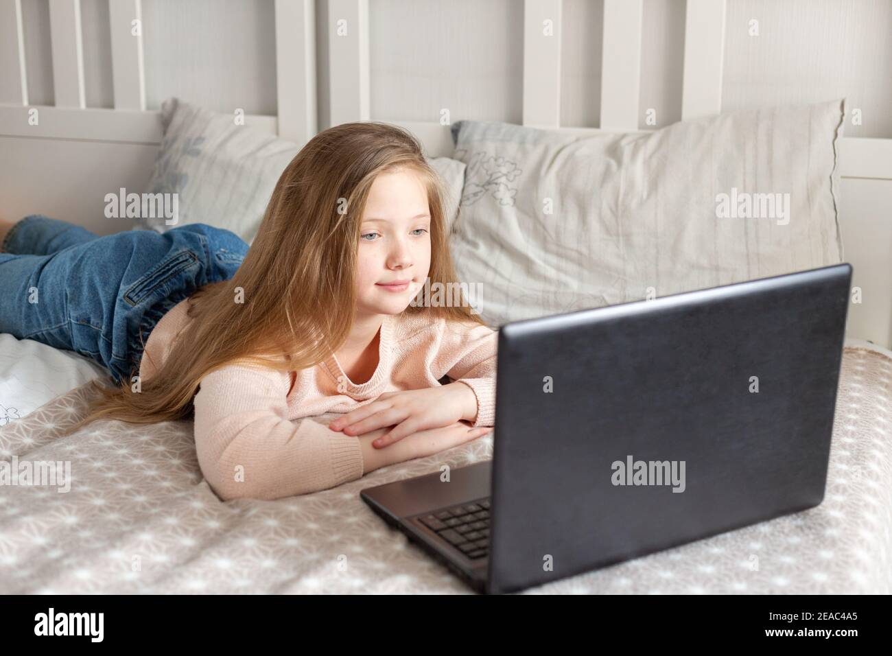 Écolière utilisant un ordinateur portable à la maison. Enseignement à distance, éducation en ligne, éducation à domicile, concept de quarantaine. Banque D'Images