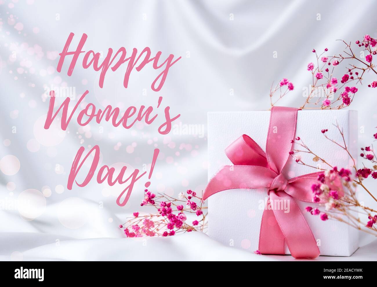 Carte de voeux à lettres « Happy Women Day ». Boîte cadeau avec ruban rose  fleurs roses sèches. Concept pastel lumineux. Femme Photo Stock - Alamy