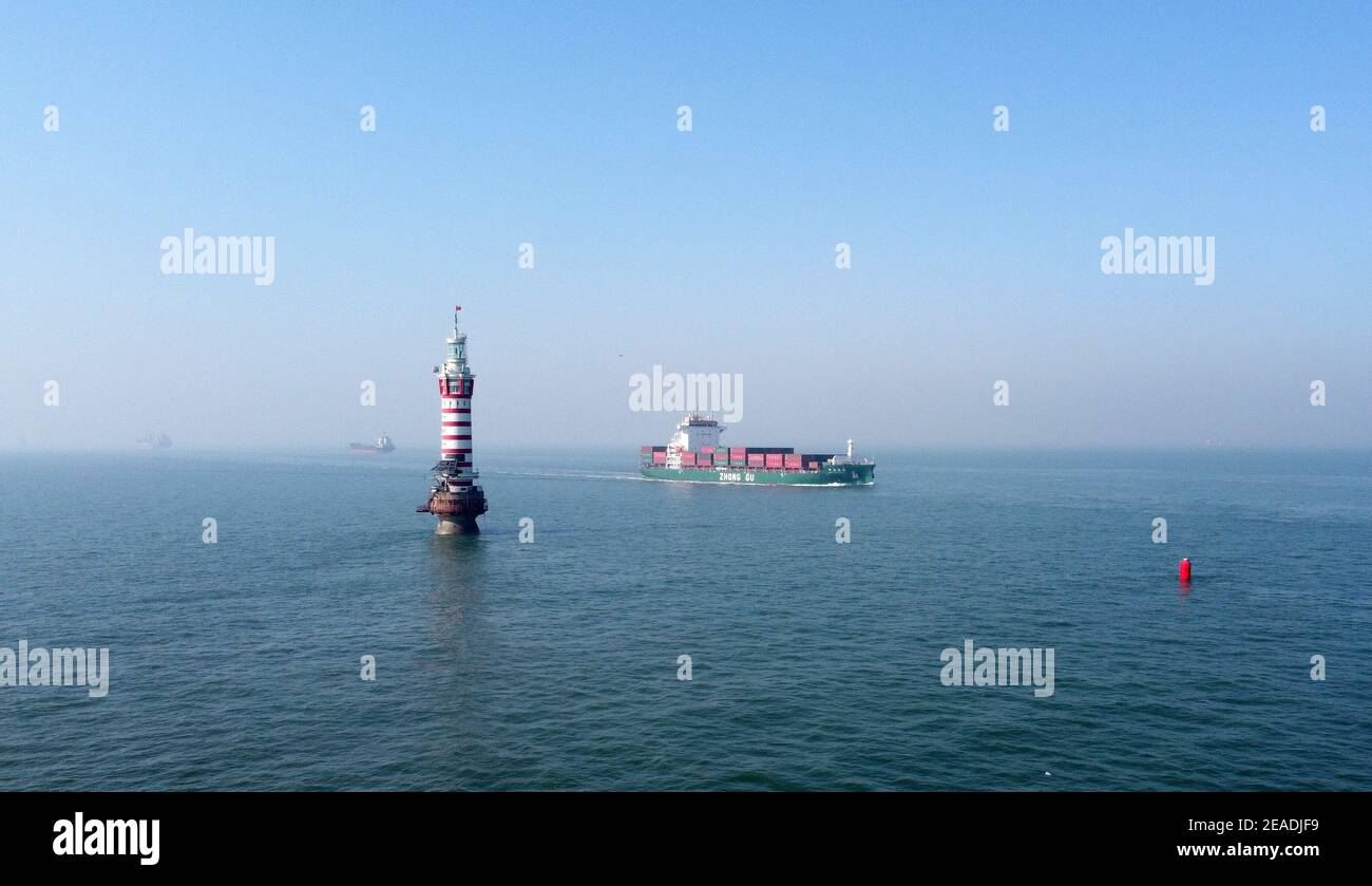 (210209) -- TIANJIN, le 9 février 2021 (Xinhua) -- une photo aérienne prise le 5 février 2021 montre le phare de Dagu qui se trouve à 12.9 milles marins à l'est du port de Tianjin de la municipalité de Tianjin, au nord de la Chine. Le phare de Dagu, d'une hauteur de 38.3 mètres, avec une portée lumineuse de 17 milles marins, est mis en service depuis le 1er mai 1978. Li Hongqi, 47 ans, est un gardien du phare de Dagu. Les gardiens travaillent ici dans une rotation d'un mois, en maintenant les lumières du phare pour garantir la sécurité de la navigation des navires. Les nécessités quotidiennes sont servies une fois par mois, et les gardiens se tournent vers les dispositifs d'éclairage et de chauffage seulement quand ils sont en dérite Banque D'Images