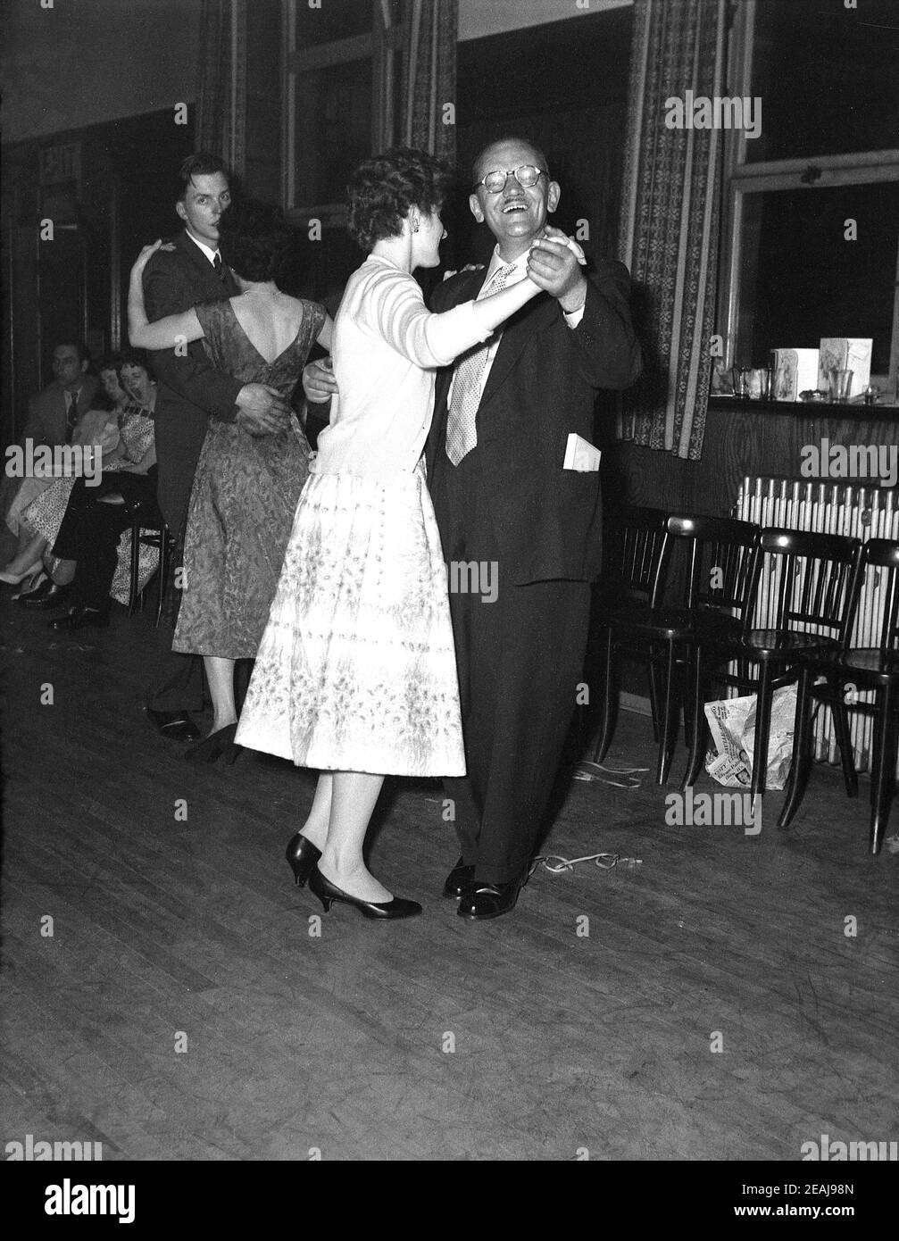 Dans les années 1950, historique, soirée et dans une grande salle de réception d'un hôtel, avec un plancher de bois, deux couples dansant lors d'une fête d'anniversaire, Leeds, Angleterre, Royaume-Uni. Banque D'Images