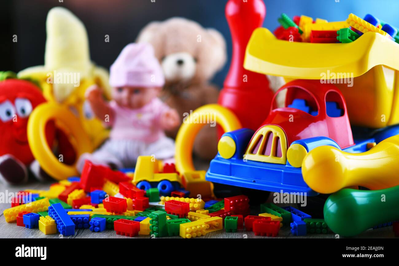 Des jouets en plastique coloré et en peluche dans la chambre des enfants Banque D'Images