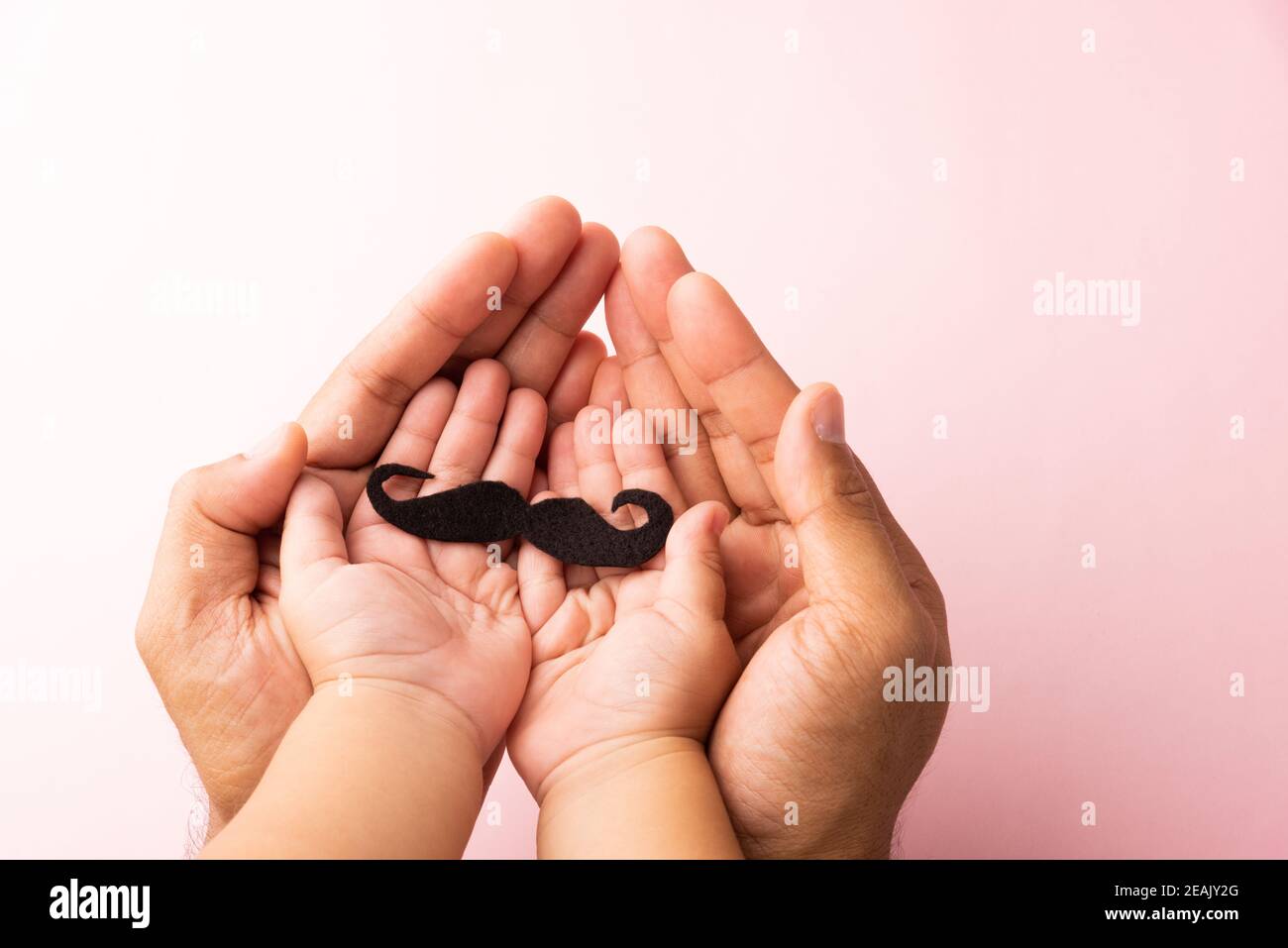 Le père et son fils gamin utilisent la main tenant la moustache noire Banque D'Images