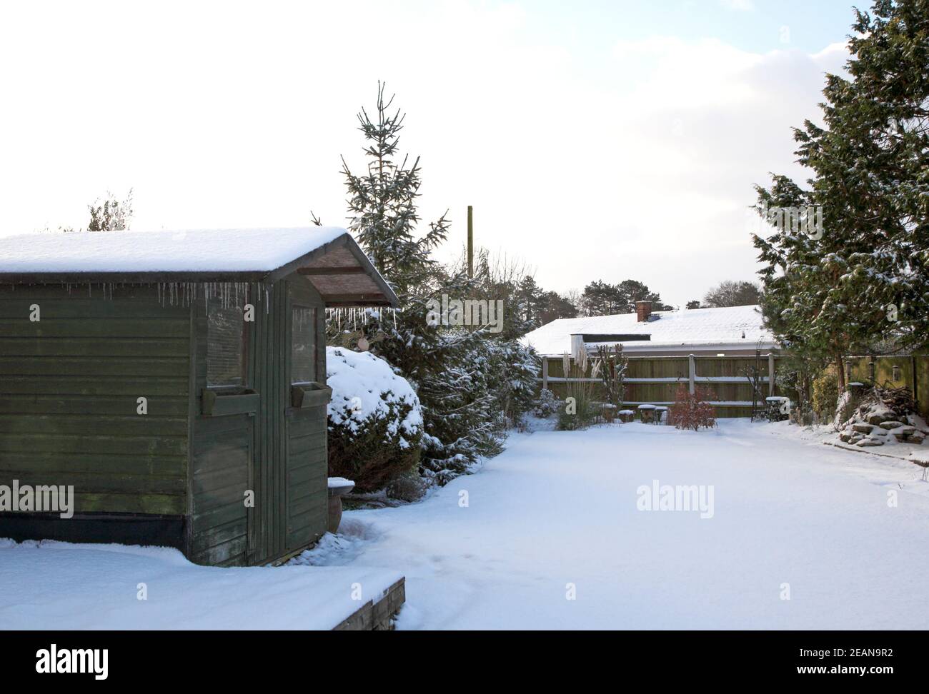 Nuage croissant sur un jardin anglais avec une couverture de neige à Hellesdon, Norfolk, Angleterre, Royaume-Uni. Banque D'Images