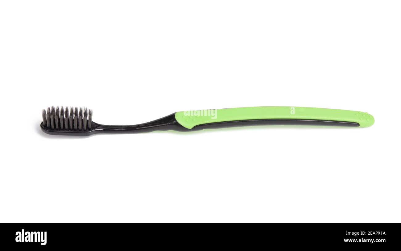 brosse à dents en plastique vert isolée sur fond blanc Banque D'Images