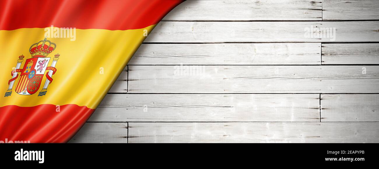 Drapeau espagnol sur l'ancienne bannière murale blanche Banque D'Images