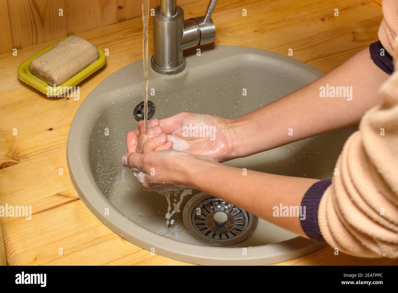 Les mains de la fille se laver le savon suds ses mains dans le lavabo Banque D'Images