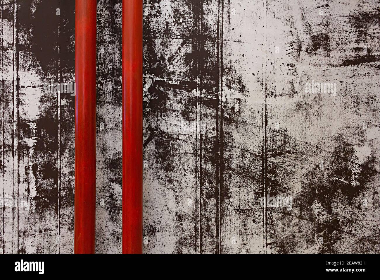 Vue en pièce de deux tuyaux rouges sur le noir et arrière-plan de mur en béton peint en chabby blanc Banque D'Images