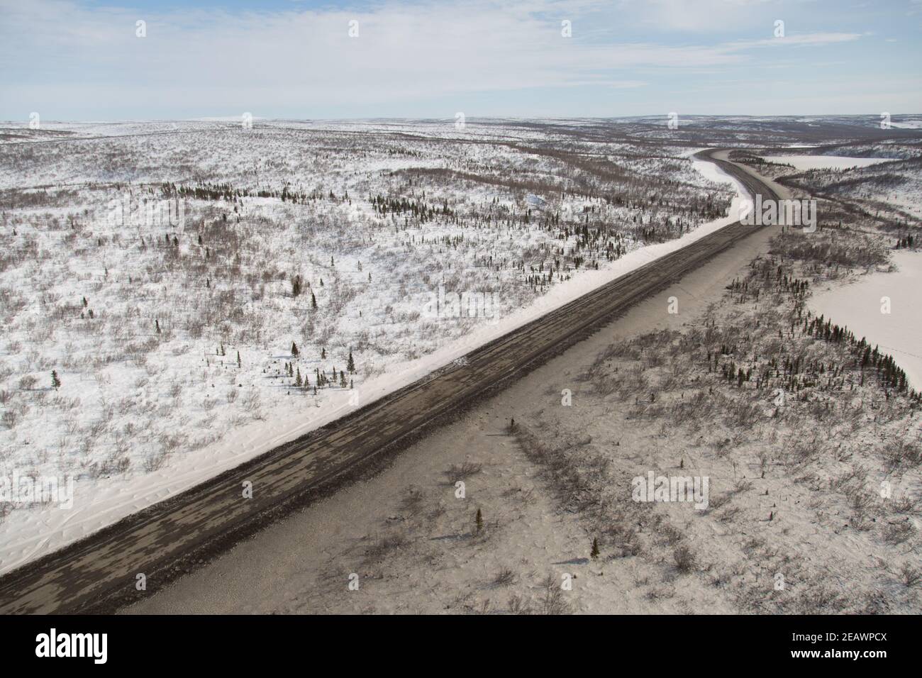 Vue aérienne en hiver du gravier de la route Inuvik-Tuktoyaktuk depuis l'extrémité sud, Territoires du Nord-Ouest, l'Arctique canadien. Banque D'Images