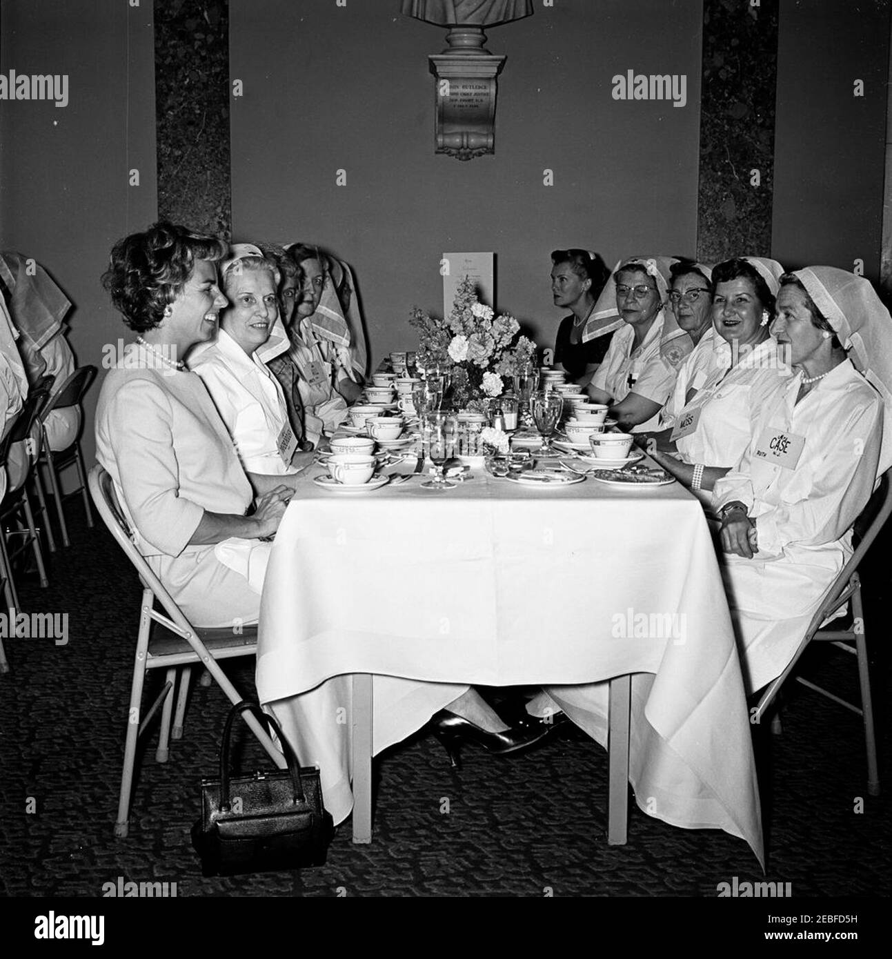 La première dame Jacqueline Kennedy (JBK) assiste au déjeuner de l'unité des femmes de la Croix-Rouge du Sénat. Description: Des membres de l'unité de la Croix-Rouge des femmes du Sénat assistent à un déjeuner dans l'ancienne chambre de la Cour suprême, bâtiment du Capitole des États-Unis, Washington, D.C. l'unité de la Croix-Rouge (également connue sous le nom de u201cLadies du Senateu201d) est composée des épouses des membres du Sénat américain. De gauche à droite : Ethel Skakel Kennedy (épouse du procureur général, Robert. F. Kennedy); Opal Warren Yarborough (épouse du sénateur Ralph Yarborough du Texas); non identifié; Henrietta Hill (épouse du sénateur Lister Hill de l'Alabama); non identifié Banque D'Images