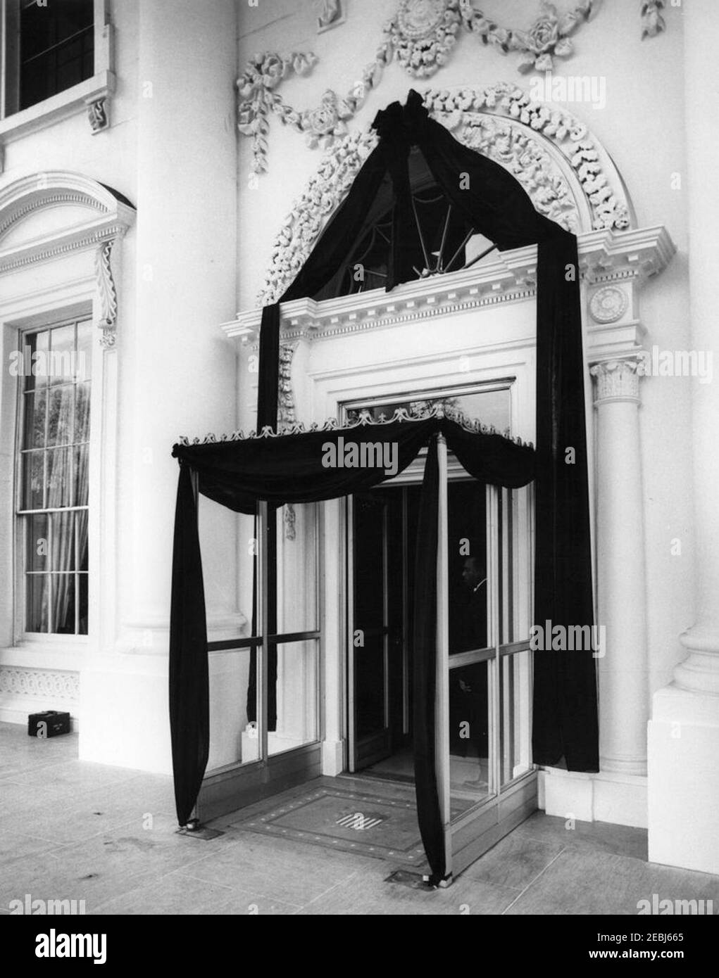 Funérailles d'État du président Kennedy : couché en repos dans la salle est de la Maison Blanche. Vue sur le Portico nord de la Maison Blanche, drapé en crêpe noire de deuil, après la mort du président John F. Kennedy. Washington, D.C. Banque D'Images