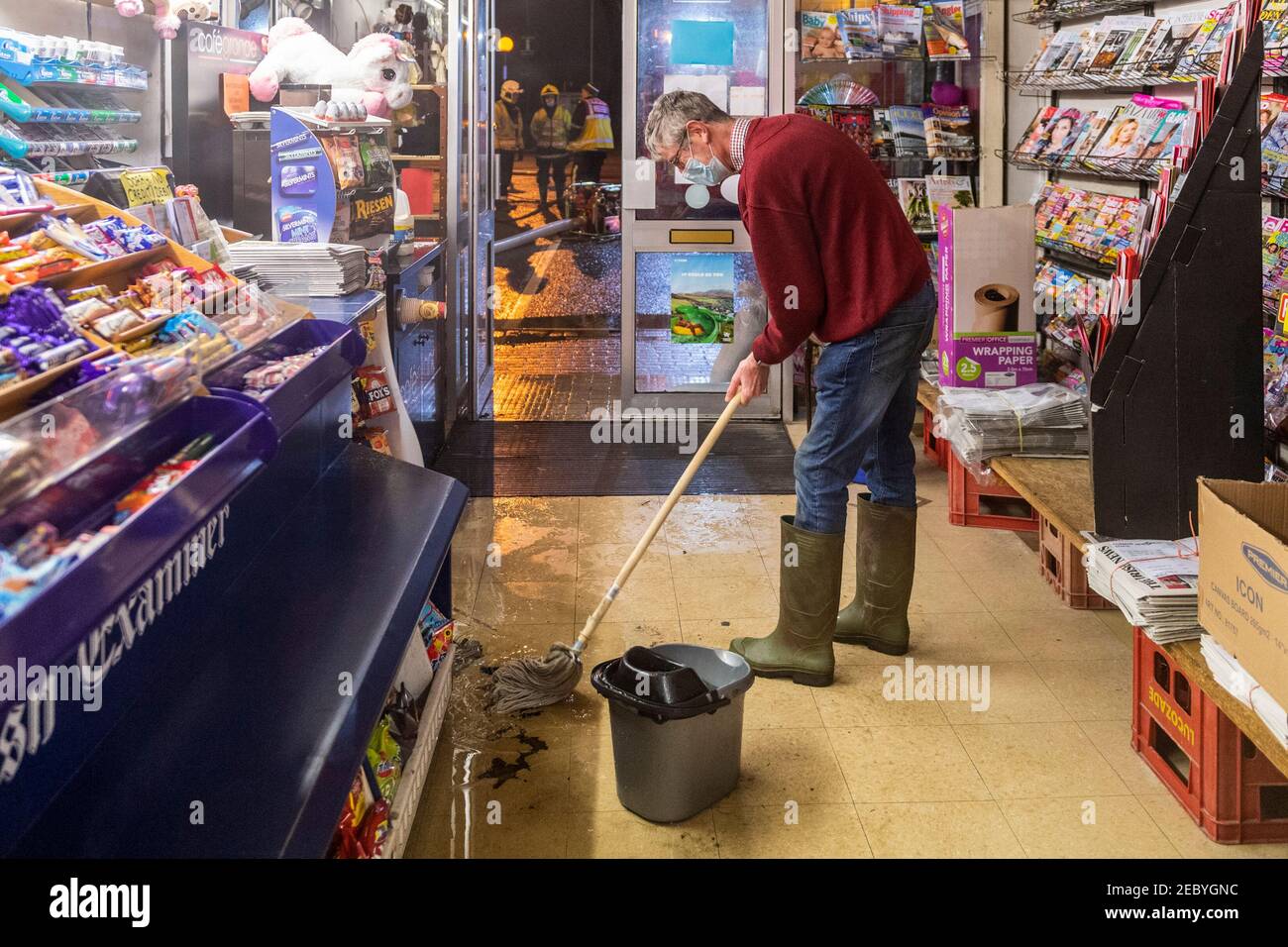 Bantry, West Cork, Irlande. 13 février 2021. La place de la ville de Bantry a de nouveau inondé ce matin, en raison des hautes marées de printemps astronomiques. Trois unités de la brigade des pompiers de Bantry ont aidé les travailleurs du Conseil du comté de Cork à pomper les eaux d'inondation loin des propriétés, bien qu'un petit nombre de locaux aient été touchés par les eaux d'inondation. Bill Alymer, de la boutique de cadeaux, des agents de presse ont essuyé les eaux d'inondation de ses locaux. Crédit : AG News/Alay Live News Banque D'Images