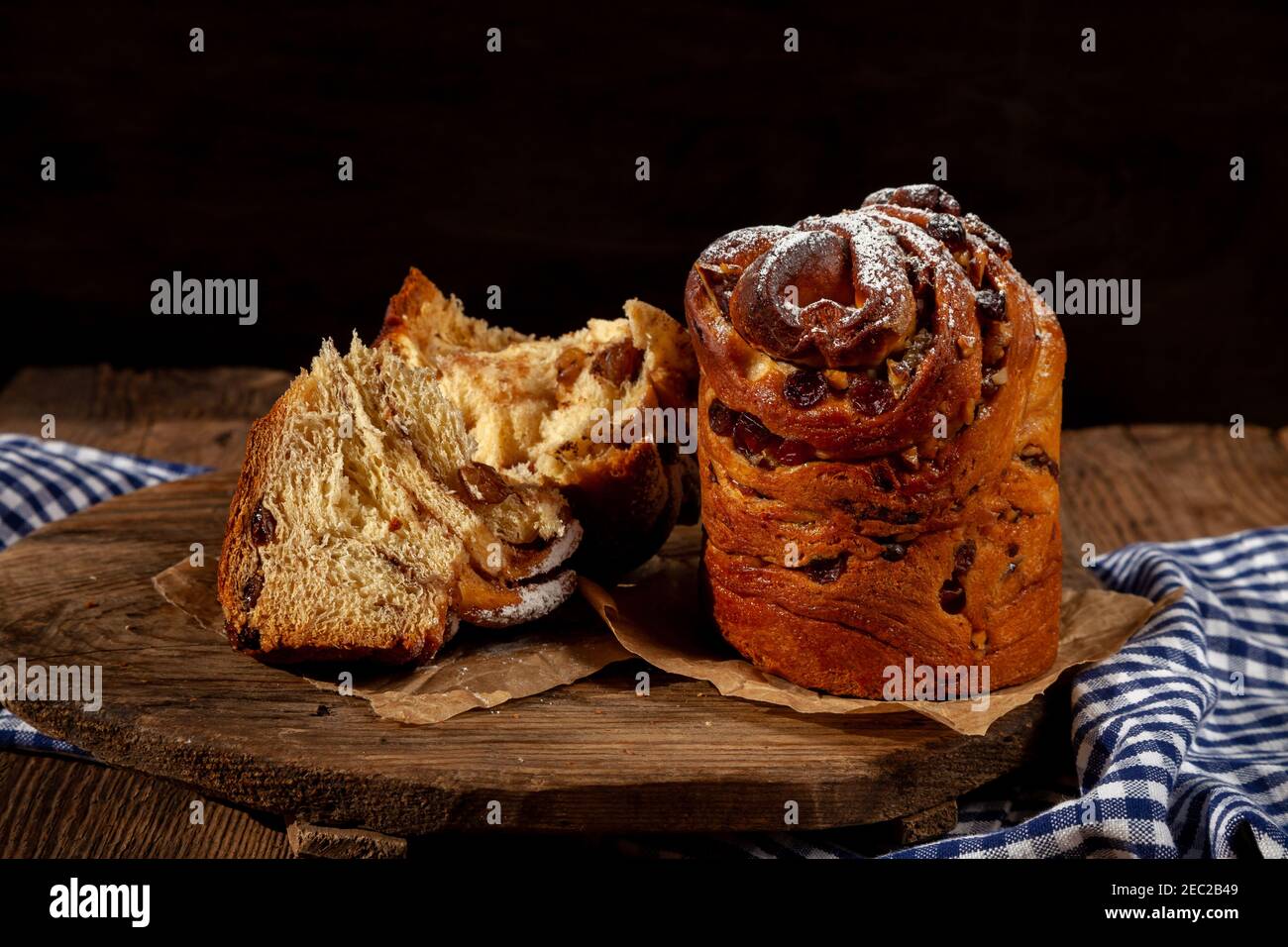 Kraffin gâteau de Pâques. Kraffins aux raisins secs, fruits confits et graines de pavot, arrosés de sucre en poudre. Gros plan de gâteau maison. Brut. Banque D'Images