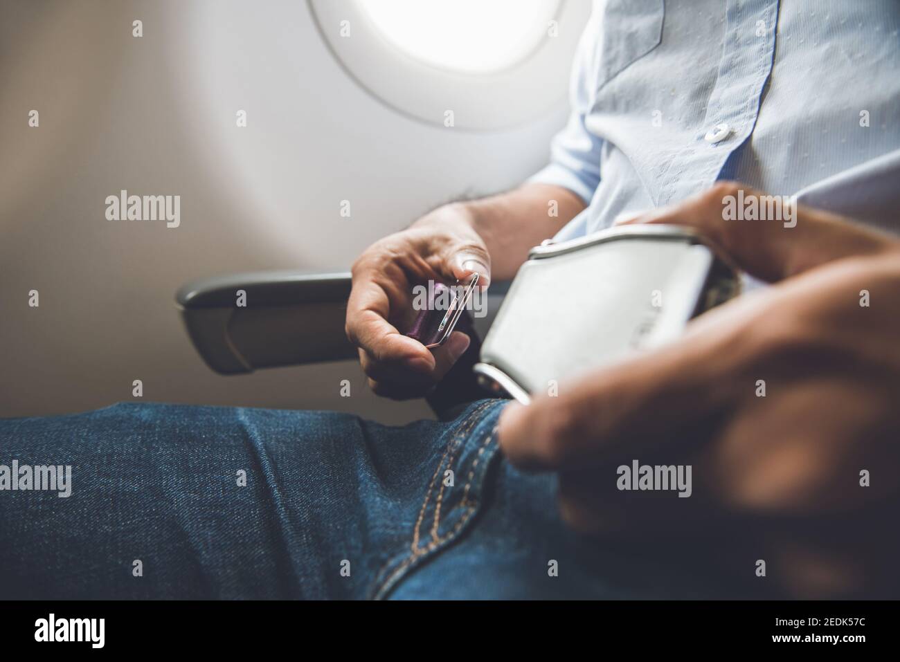 Homme passager boutant la ceinture de sécurité en étant assis dans l'avion pour la sécurité en vol Banque D'Images