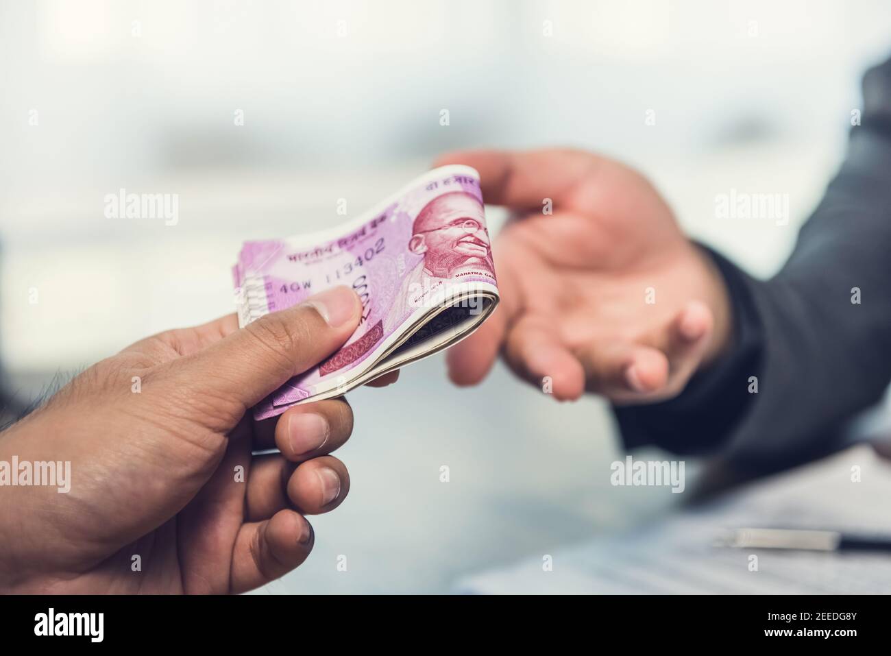 Homme d'affaires donnant de l'argent, monnaie de roupie indienne, au partenaire hs - paiement, prêt et corruption concept Banque D'Images