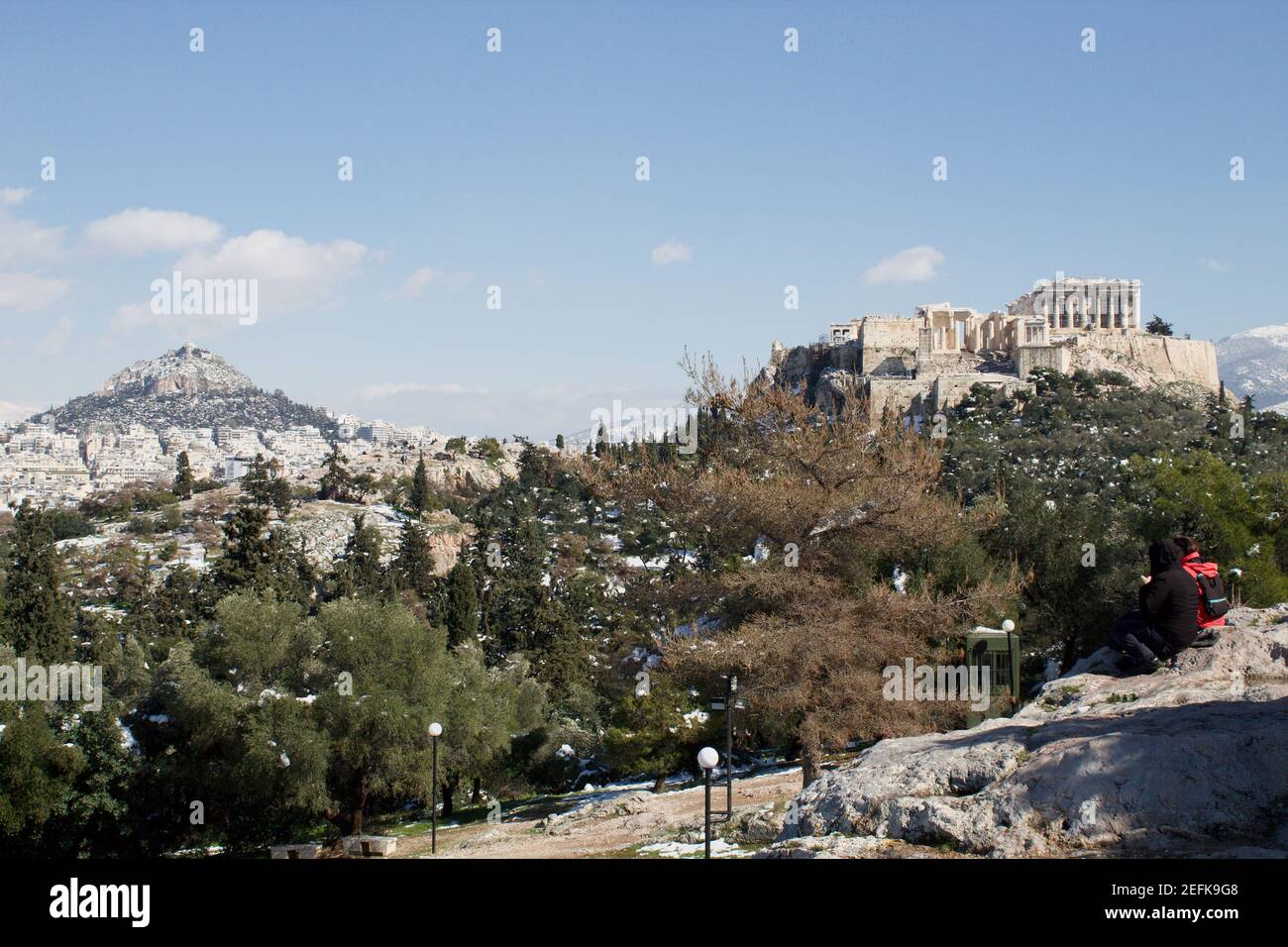 Athènes, Grèce - février 17 2021 : vue sur l'Acropole en hiver, avec de la neige dans les montagnes. Monter Lycabette en arrière-plan Banque D'Images