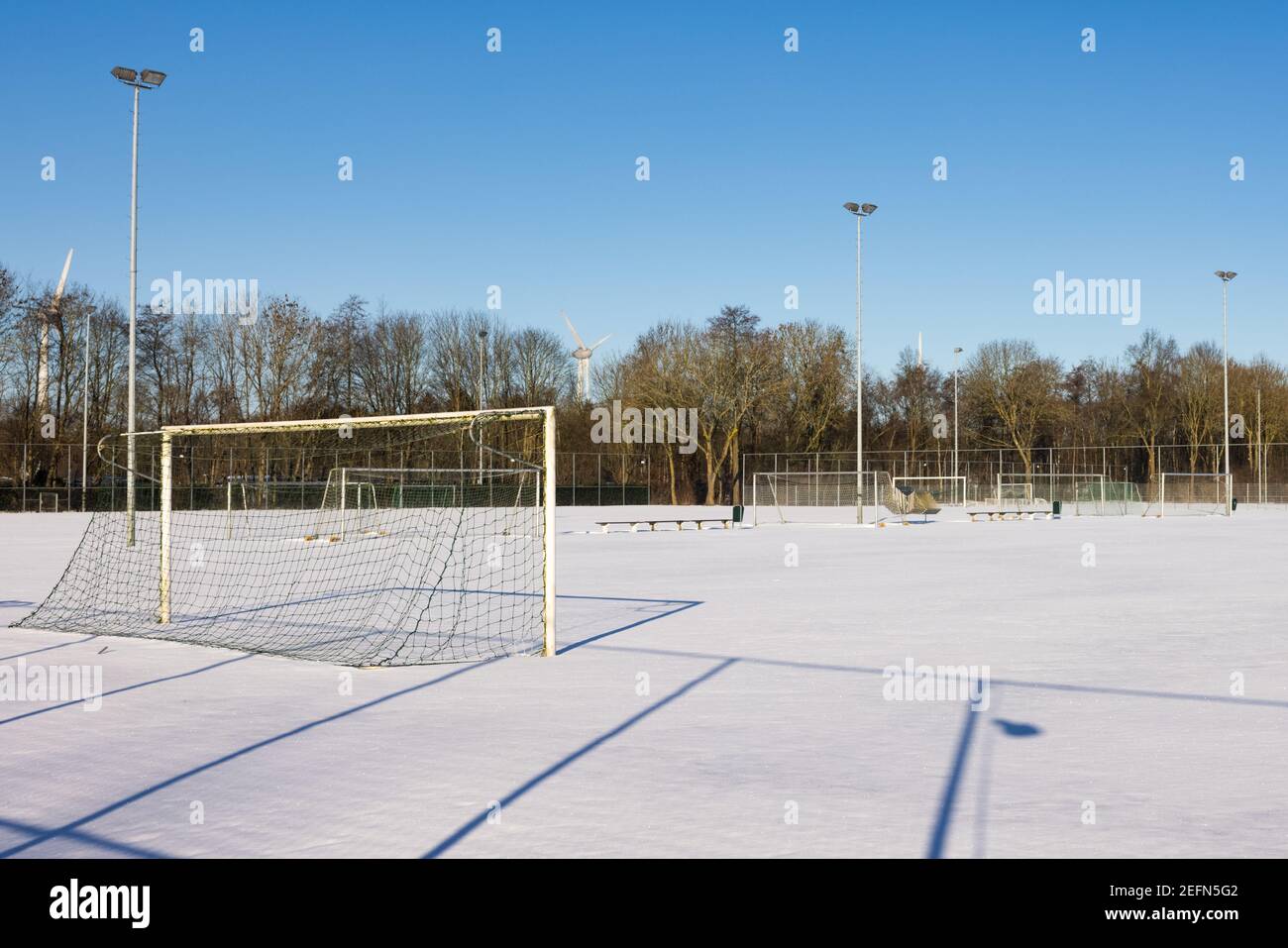 Terrain de football avec des buts couverts de neige blanche Banque D'Images