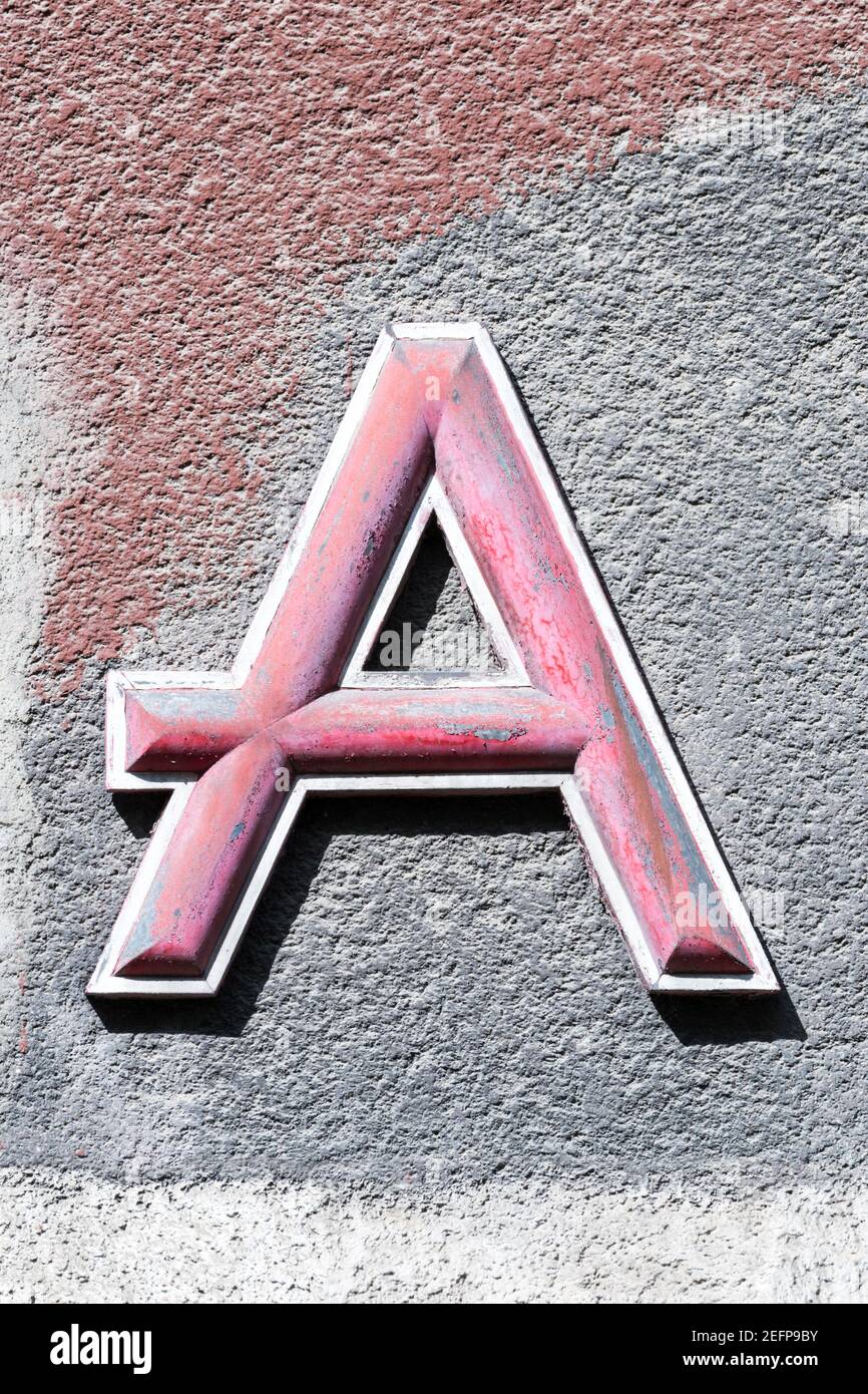 Lettre rose A sur la couleur peint mur de maison Banque D'Images