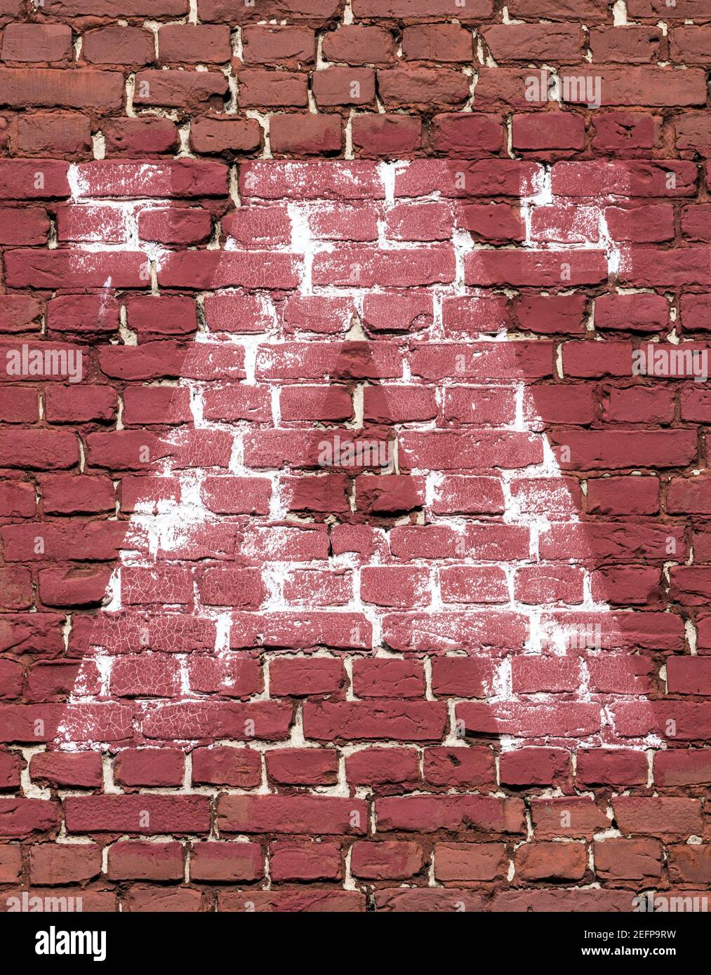 La lettre Ä (AE) peint en blanc sur une brique rouge mur Banque D'Images