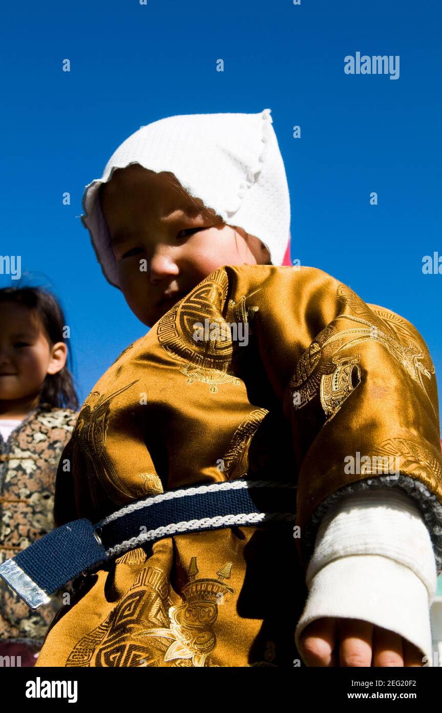 Un adorable garçon mongol vêtu de sa tenue traditionnelle. Banque D'Images