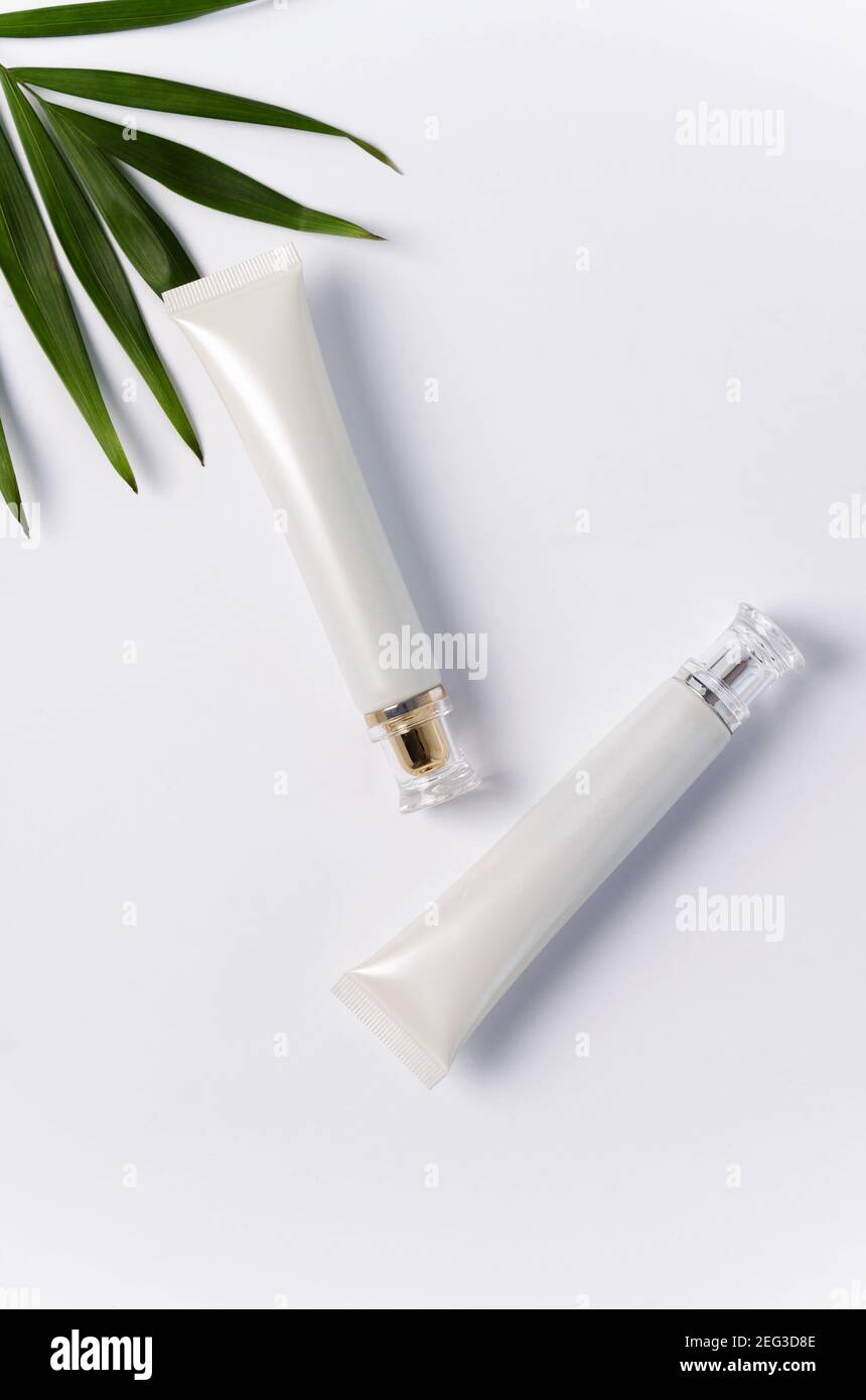 Crème pour le soin de la peau autour des yeux dans un tube blanc sur fond blanc, vue de dessus. Produit cosmétique de beauté pour les soins de la peau. Lotion dans un coup Banque D'Images