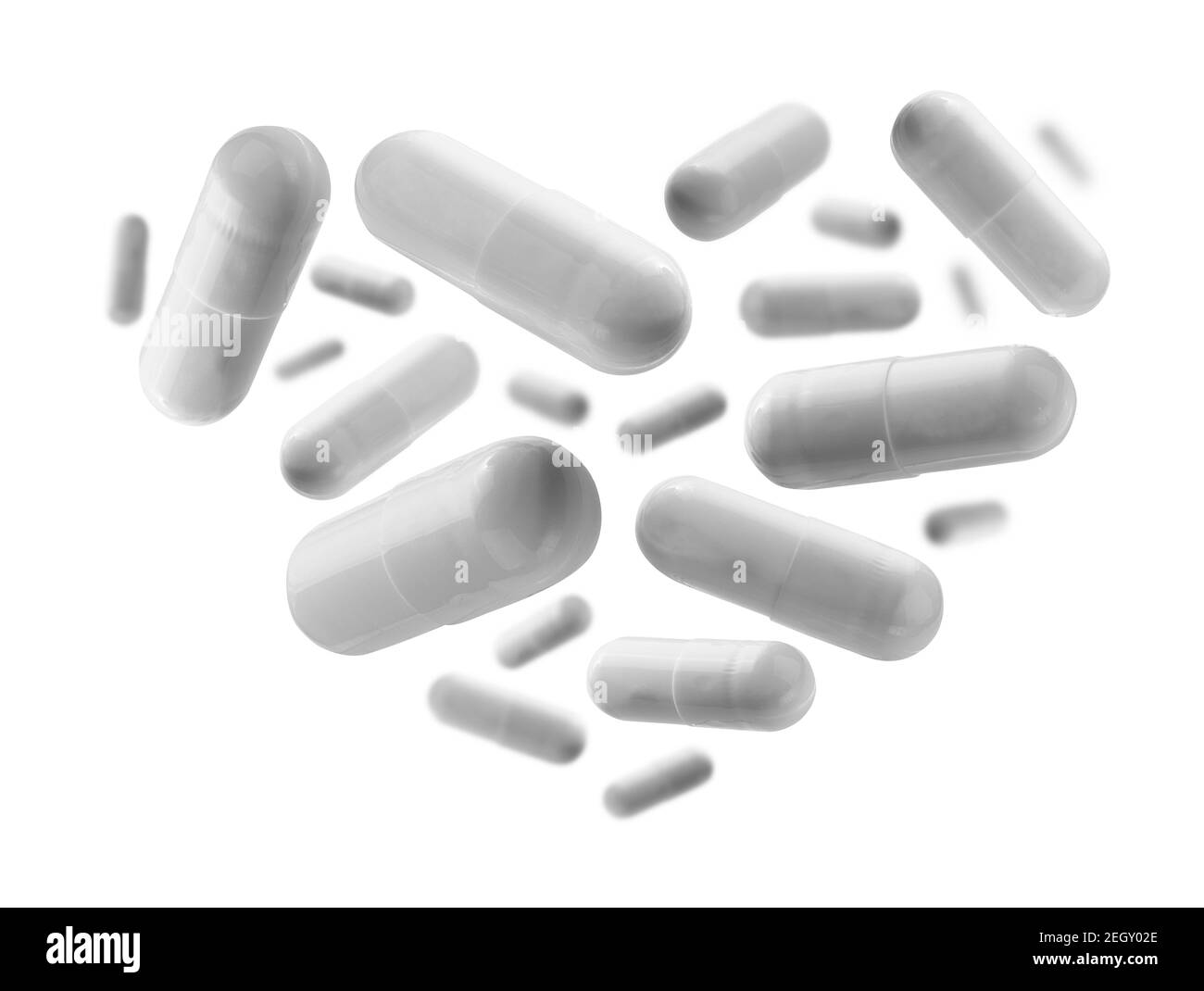 Capsules avec le médicament en forme de coeur sur fond blanc Banque D'Images