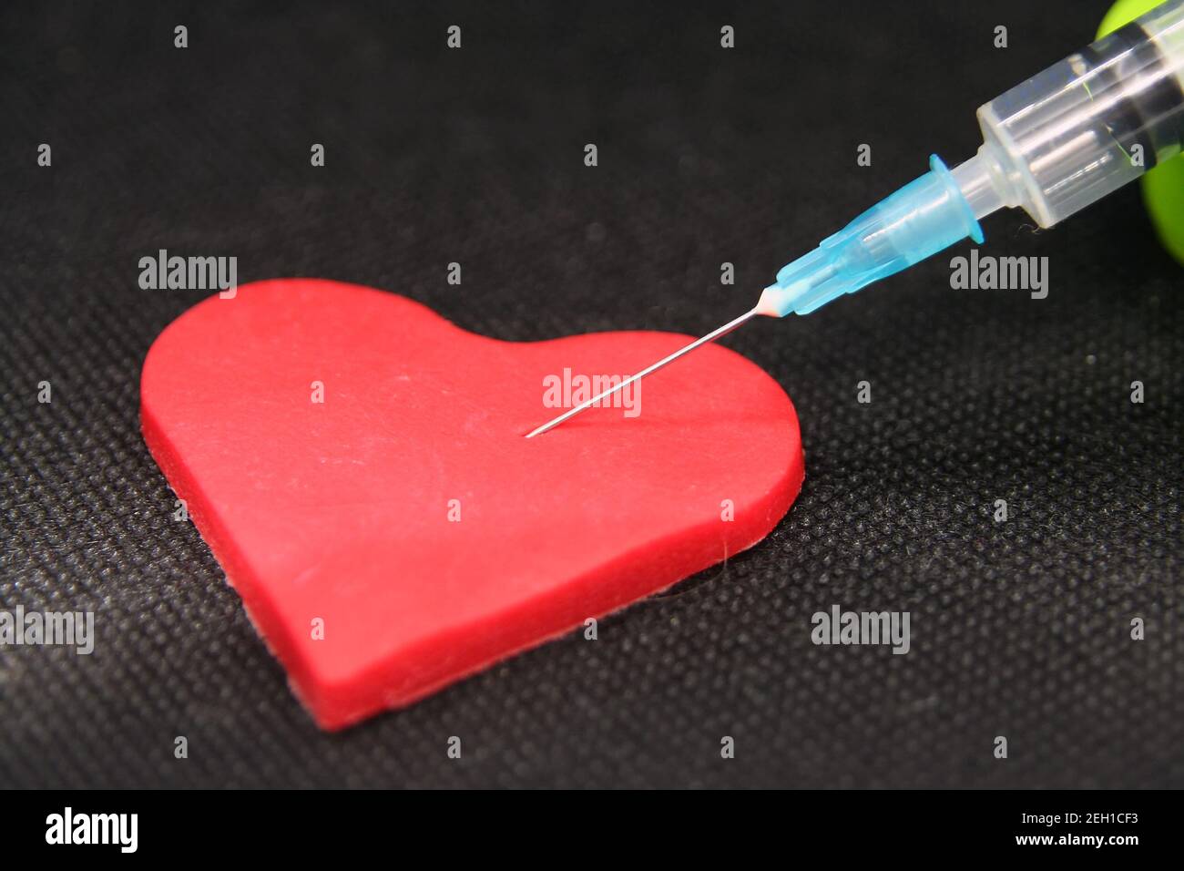 Seringue médicale et un coeur. Objet en forme de coeur et un traitement. Banque D'Images