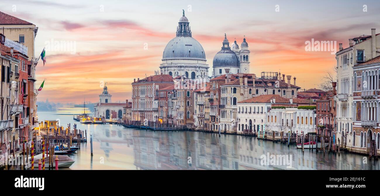 Vue imprenable sur les gratte-ciel de Venise avec le Grand Canal et la basilique Santa Maria Della Salute au loin pendant un lever de soleil spectaculaire. Banque D'Images