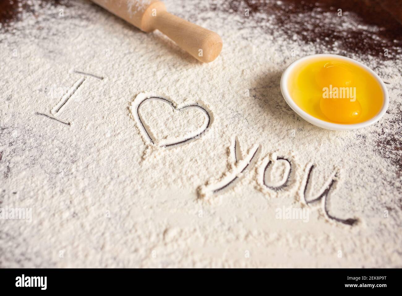 L'inscription Je vous aime sur la farine saupoudrée, la rollPIN et les oeufs. Recettes de boulangerie. Concept de la Saint-Valentin. Déclaration d'amour Banque D'Images