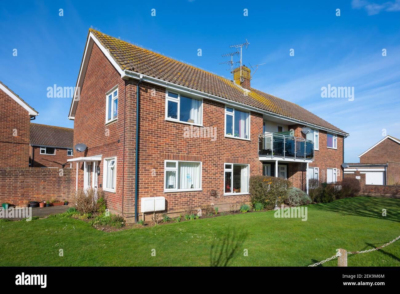Petit immeuble moderne de 2 étages avec pelouse commune à l'avant, dans un quartier résidentiel calme à Rustington, West Sussex, Angleterre, Royaume-Uni. Banque D'Images