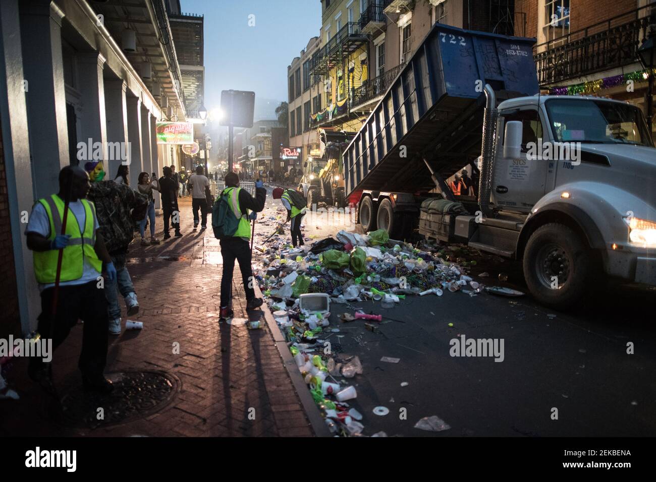 Les travailleurs de l'assainissement s'attaquent à la tâche redoutable de nettoyer la rue Bourbon, jonchée de déchets, à la suite des célébrations de mardi gras à la Nouvelle-Orléans. Banque D'Images