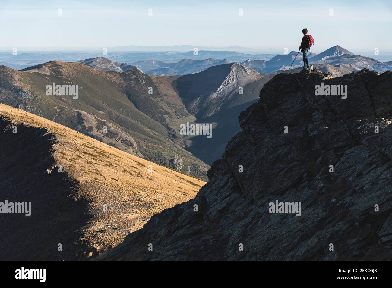 Jeune explorateur mâle sur une colline contre un ciel dégagé Banque D'Images