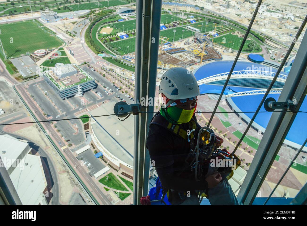 QATAR, Doha, aspire Dome et SPARK au stade international de Khalifa pour la coupe du monde de la FIFA 2022, travailleur migrant philippin travaille comme nettoyeur de fenêtre à la tour Aspire / KATAR, Doha, Fussballfelder und Sportpark am Khalifa International Stadium fuer die FIFA Fussballweltmeisterschaft 2022, phippinische Gastarbeiter arbeals Fensteriten reiniger Tower Aspire Banque D'Images