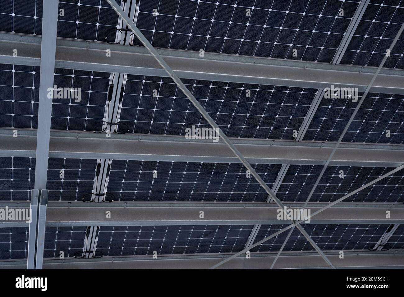 Vue de dessous d'un système de panneaux solaires construit sur des poutres métalliques en acier dans Airdrie Alberta Canada. Banque D'Images