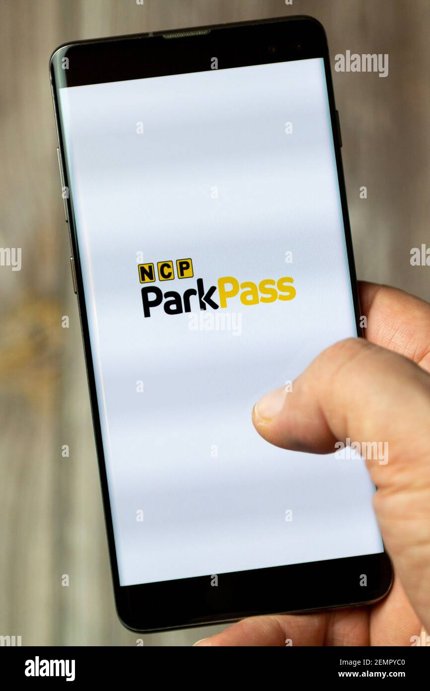 Un téléphone mobile ou mobile détenu par un Main avec l'application NCP Park Pass ouverte à l'écran Banque D'Images