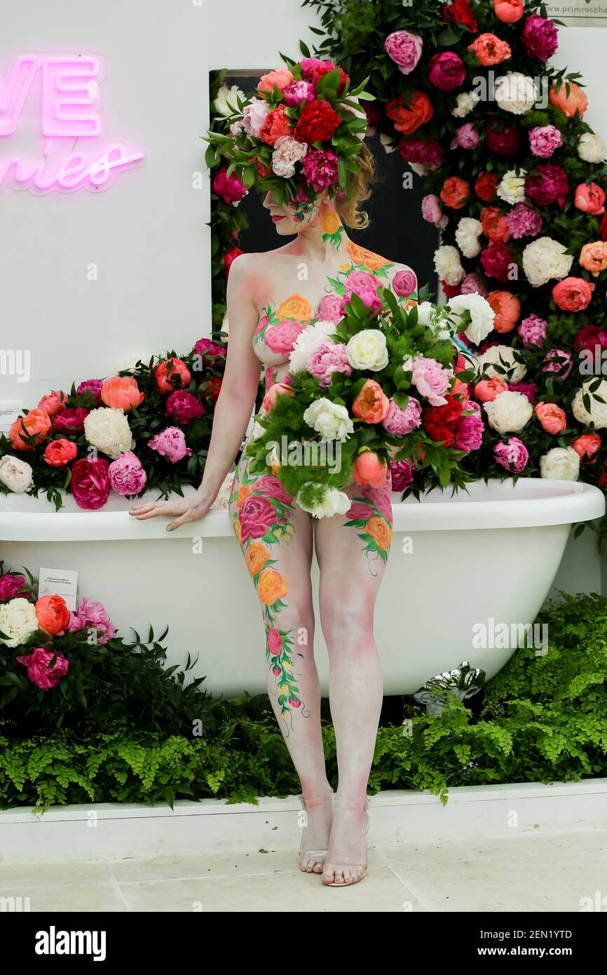 Un modèle vu portant un chapeau d'étalage floral avec l'art du corps posant  pour les photographes pendant le spectacle de fleurs de Chelsea. Le Royal  Horticultural Society Chelsea Flower Show est un