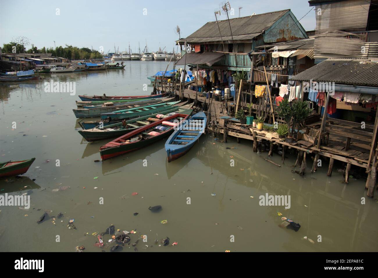 Des bateaux en bois et un village populairement connu sous le nom de Luar Batang, sur l'estuaire de la rivière Ciliwung, photographiés dans un fond de Sunda Kelapa traditionnel port dans la zone côtière de Jakarta, Indonésie (2008). Banque D'Images