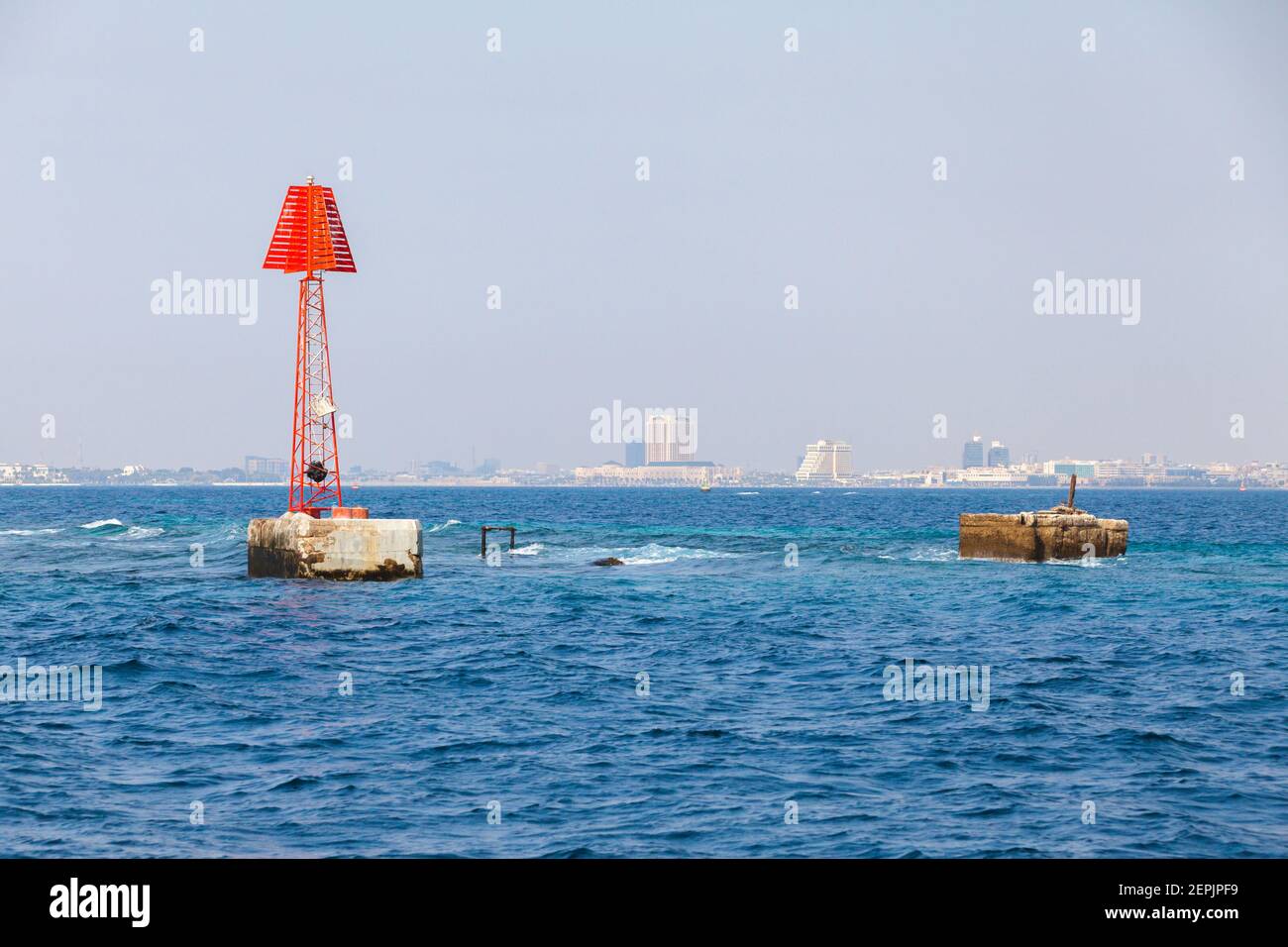 Tour de navigation rouge encadrée avec une marque triangulaire se dresse près de l'épave dans l'eau du golfe Persique, Arabie Saoudite Banque D'Images