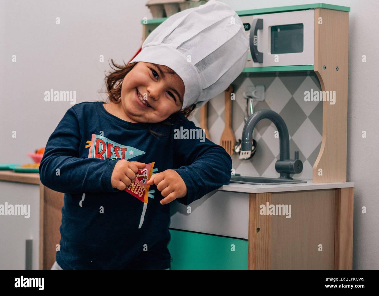 Petite Fille Jouant Avec La Cuisine De Jouet Image stock - Image du  chapeau, plaque: 73464053