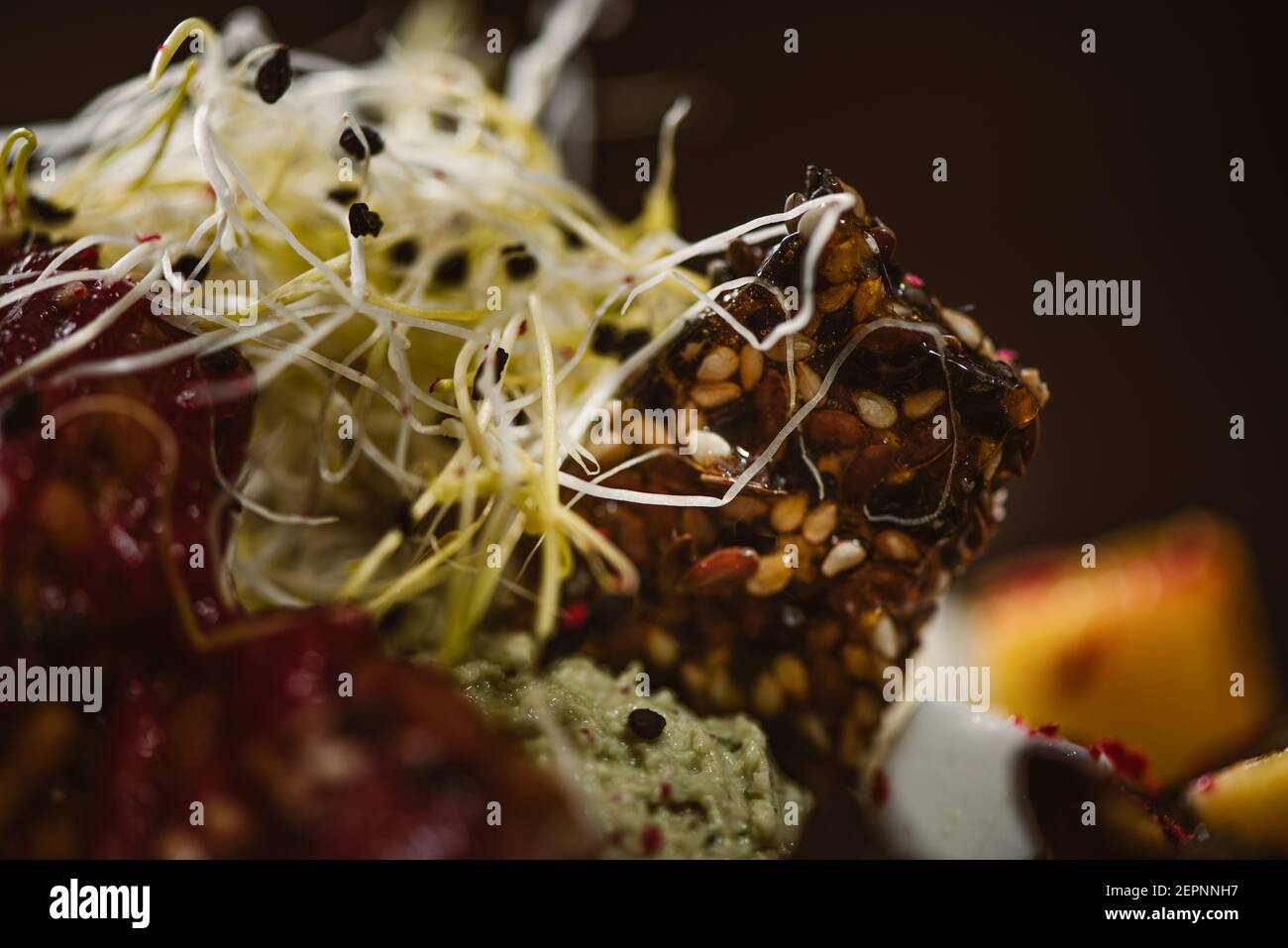 Vue rapprochée de l'assiette avec de savoureuses salades indonésiennes végétariennes avec des tranches de mangue fraîche et de fromage à la noix de cajou près du soja et condiments couverts de basi Banque D'Images