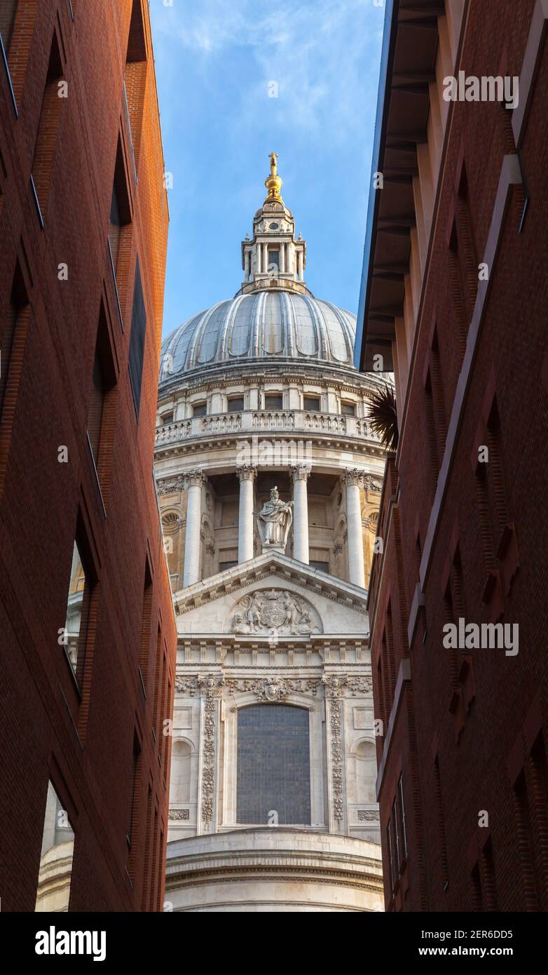 Dôme de la cathédrale Saint-Paul sous le ciel bleu entre les murs des vieilles maisons. Londres, Royaume-Uni Banque D'Images