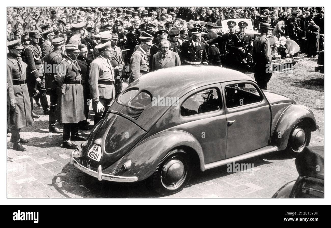 1930 Adolf Hitler avec DR. PORSCHE lors de l'événement de lancement de "la voiture du peuple' Volkswagen Coccinelle VW KDF un prototype automobile refroidi par air à Fallersleben Wolfsburg Allemagne Mai 1938 Adolf Hitler's Open Top Automobile Mercedes en arrière-plan la Mercedes-Benz 770 Grosser Offener Tourenwagen Banque D'Images